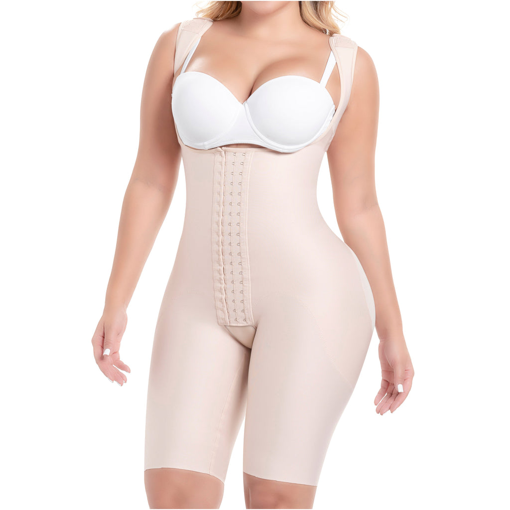 Woman wearing a beige body shaper and white bra on a white background