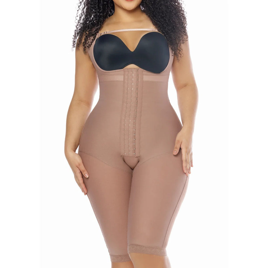 Woman wearing a beige shapewear bodysuit on a white background