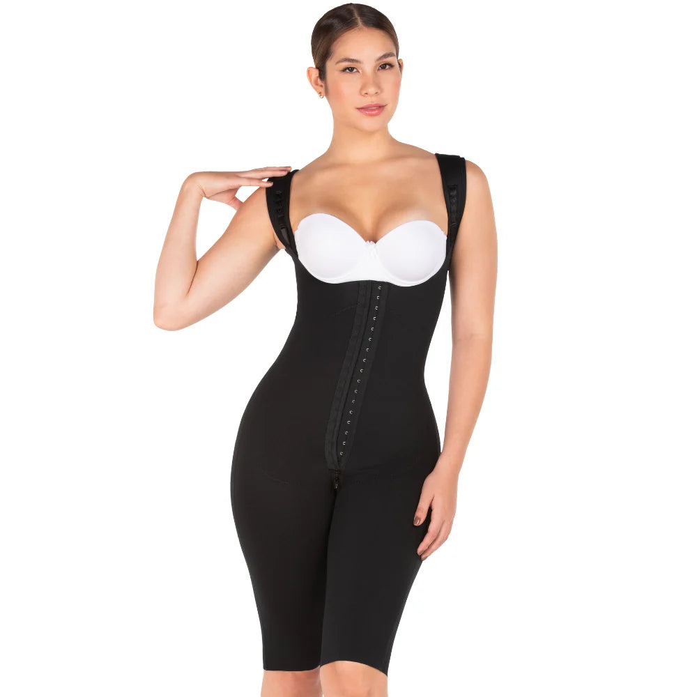 Woman wearing a black waist trainer on a white background