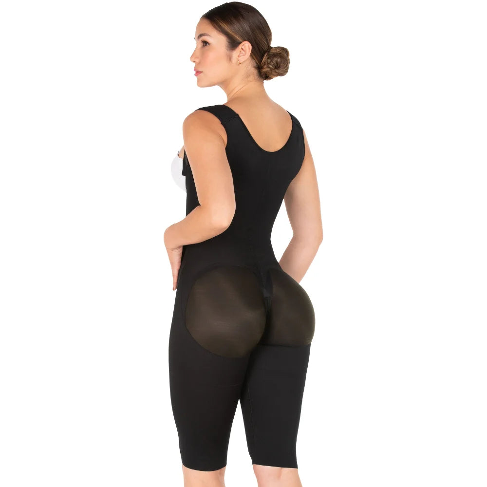 Woman wearing a black bodysuit with sheer panels on a white background