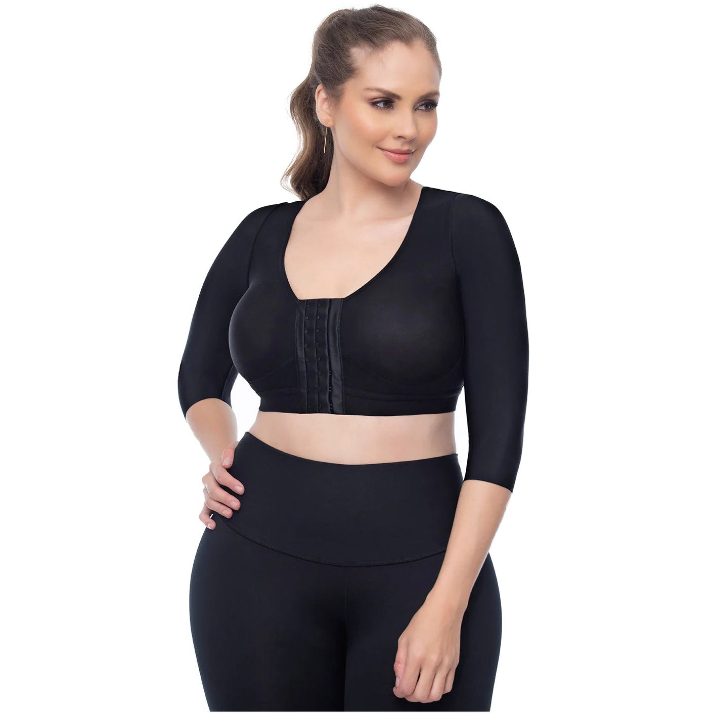 Woman wearing a black athletic outfit on a white background