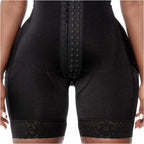 Black shapewear garment with lace trim on a neutral background