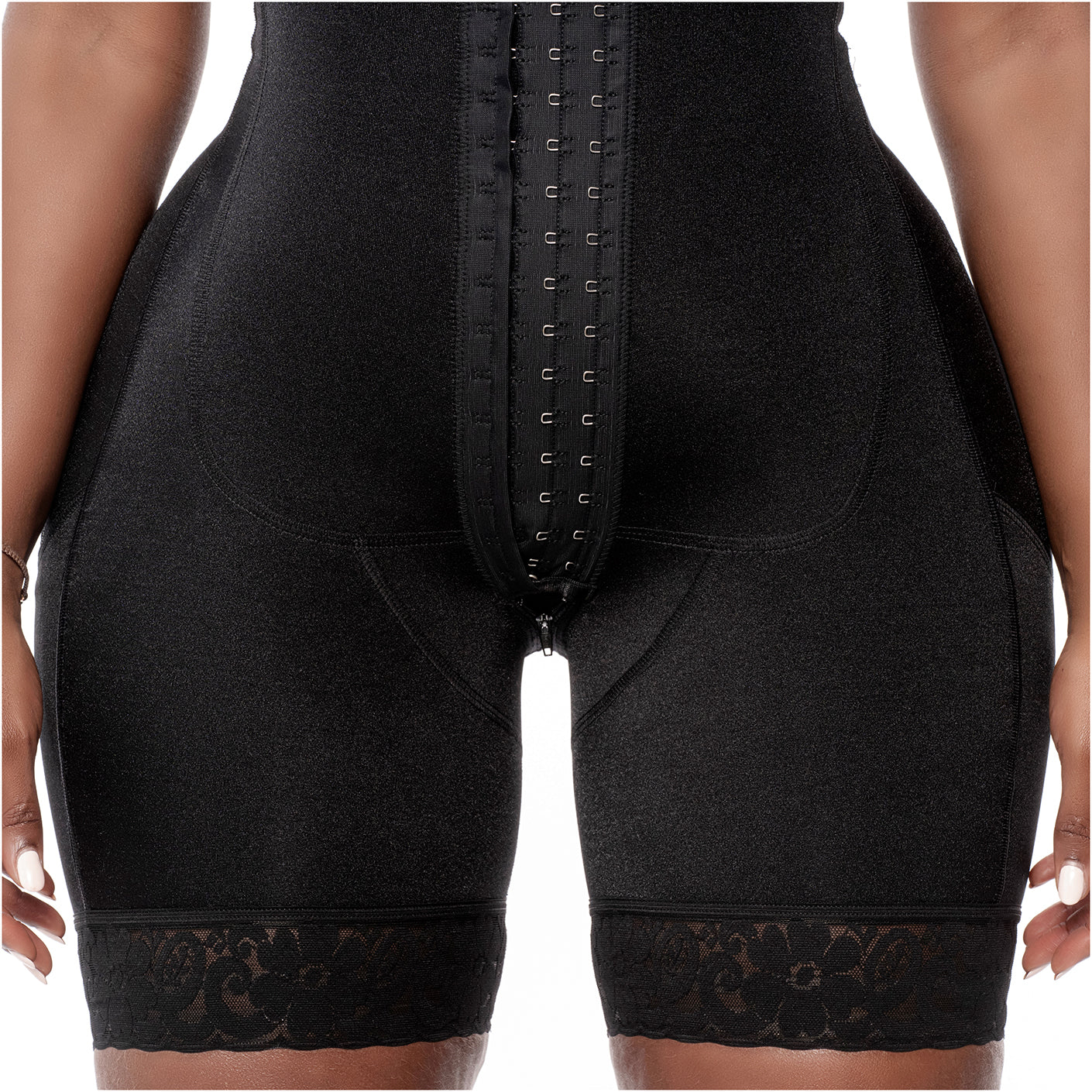 Black shapewear garment with lace trim on a neutral background