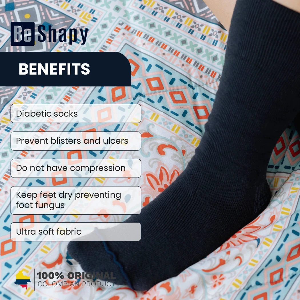 Person wearing black diabetic socks with text listing benefits on a colorful patterned surface.