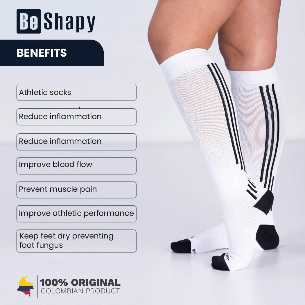 White athletic socks with black stripes on a person's legs, featuring the brand 'Be Shapy' and its benefits.