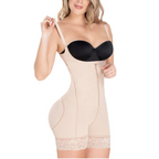 Woman wearing a black bra and beige shapewear on a white background