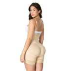 Woman wearing a beige shapewear garment on a white background