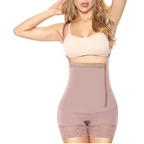 Woman wearing a beige sports bra and pink compression garment on a white background