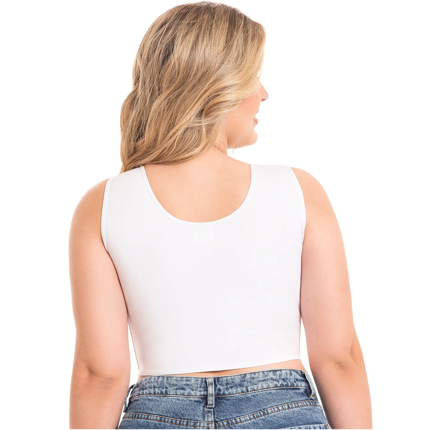 Woman wearing a white long bra and blue jeans on a white background