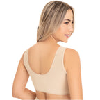 Woman wearing a beige tank top on a white background
