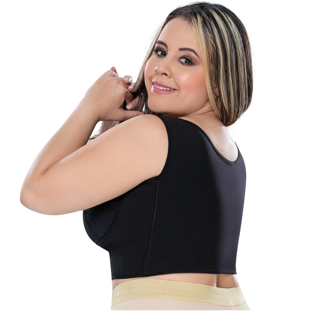 Woman wearing a black bra on a white background