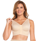 Woman wearing a beige bralette on a white background