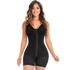 Woman wearing a black shapewear bodysuit on a white background
