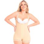 Woman wearing a beige body shaper with a white bra on a white background