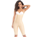 Woman wearing a beige shapewear jumpsuit with a white bra on a white background