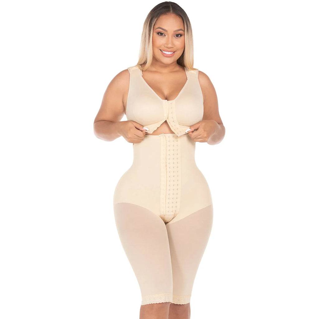Woman wearing a beige shapewear bodysuit on a white background