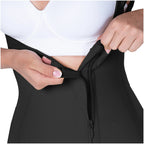 Person wearing a black waist trainer with a white background