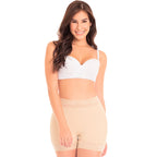 Woman wearing a white bra and beige shapewear on a white background