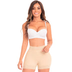 Woman wearing a white bra and beige shorts on a white background