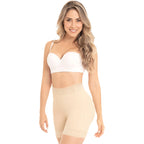 Woman wearing a white bra and beige shapewear on a white background