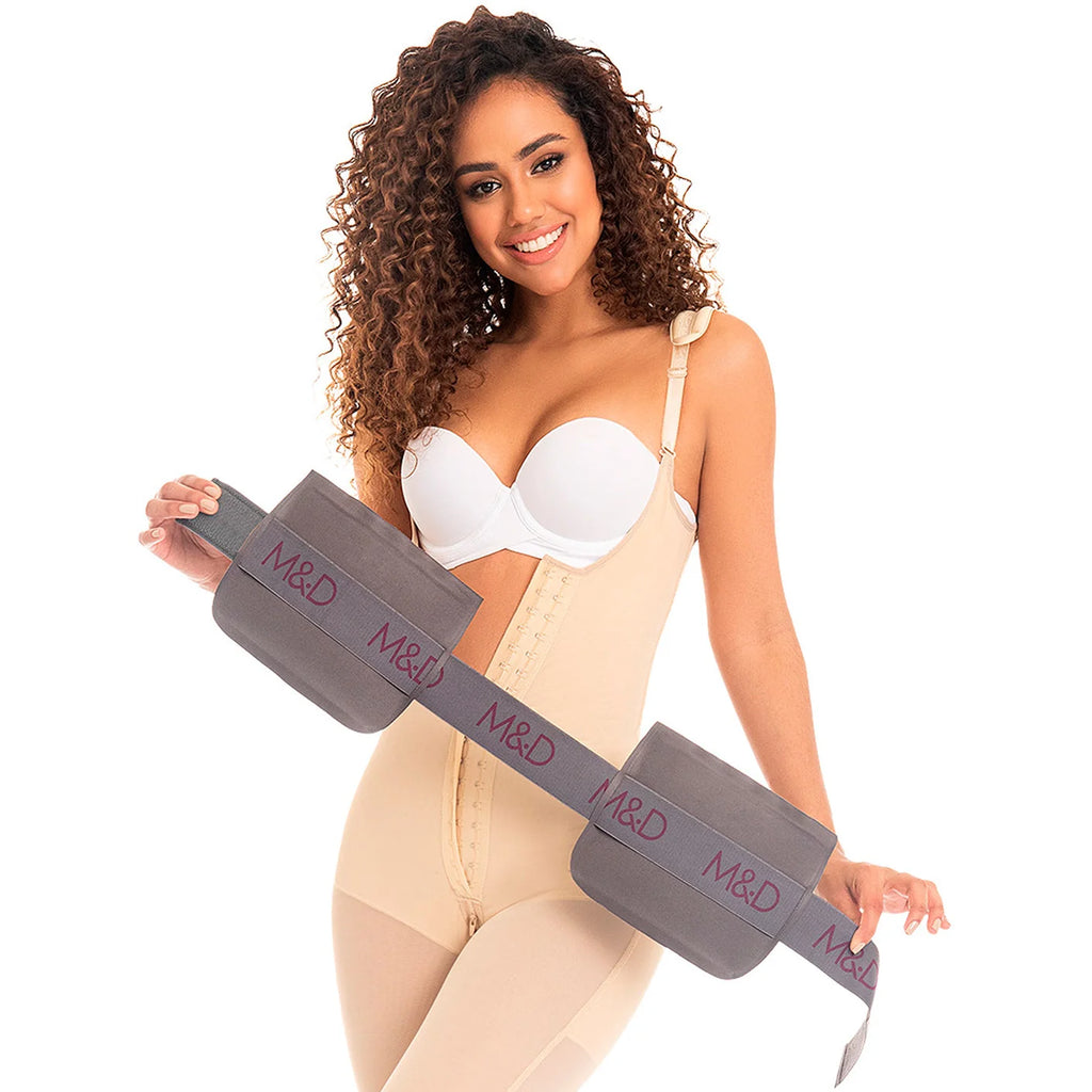 Woman wearing a beige body shaper with a visible waist trainer on a white background