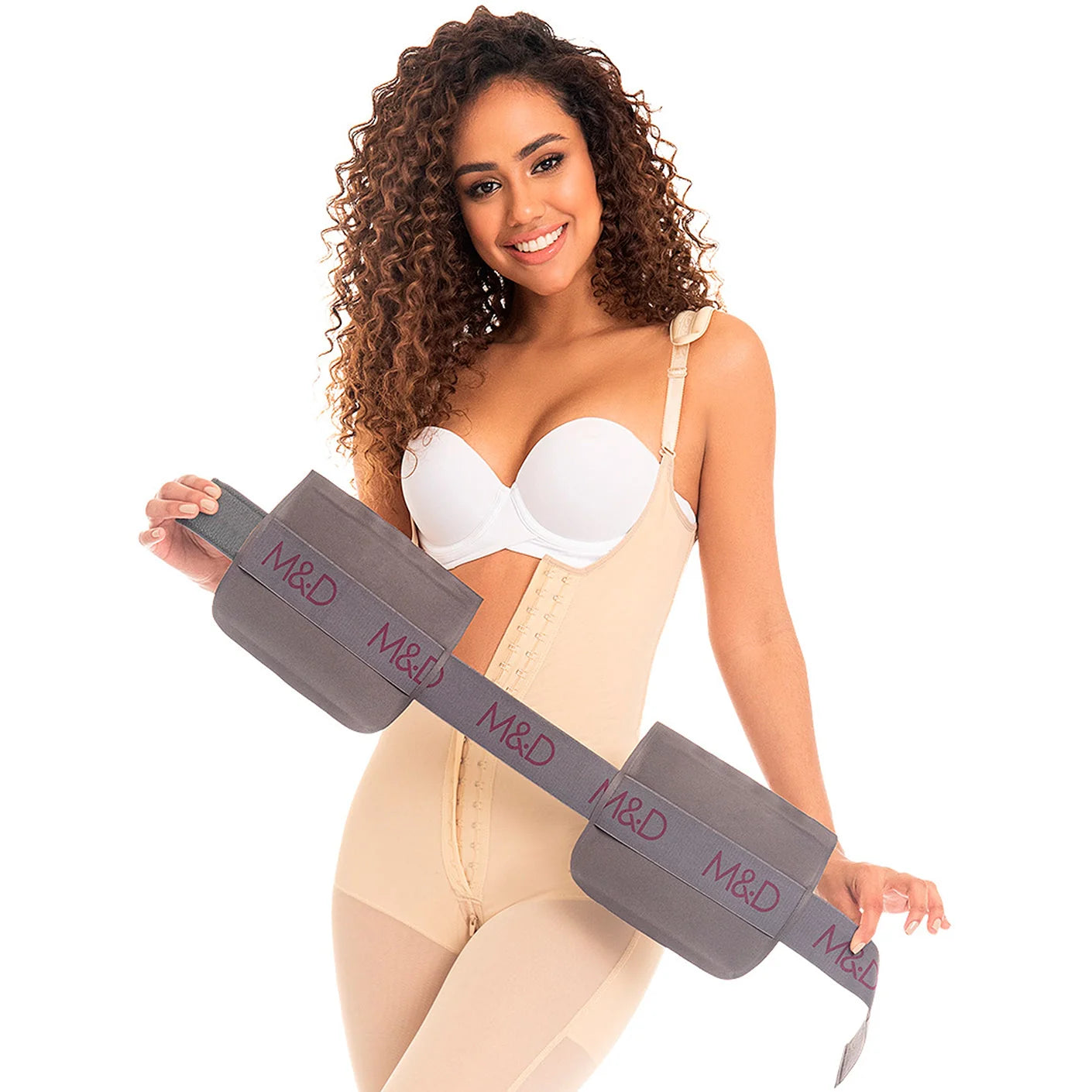 Woman wearing a beige body shaper with a visible waist trainer on a white background