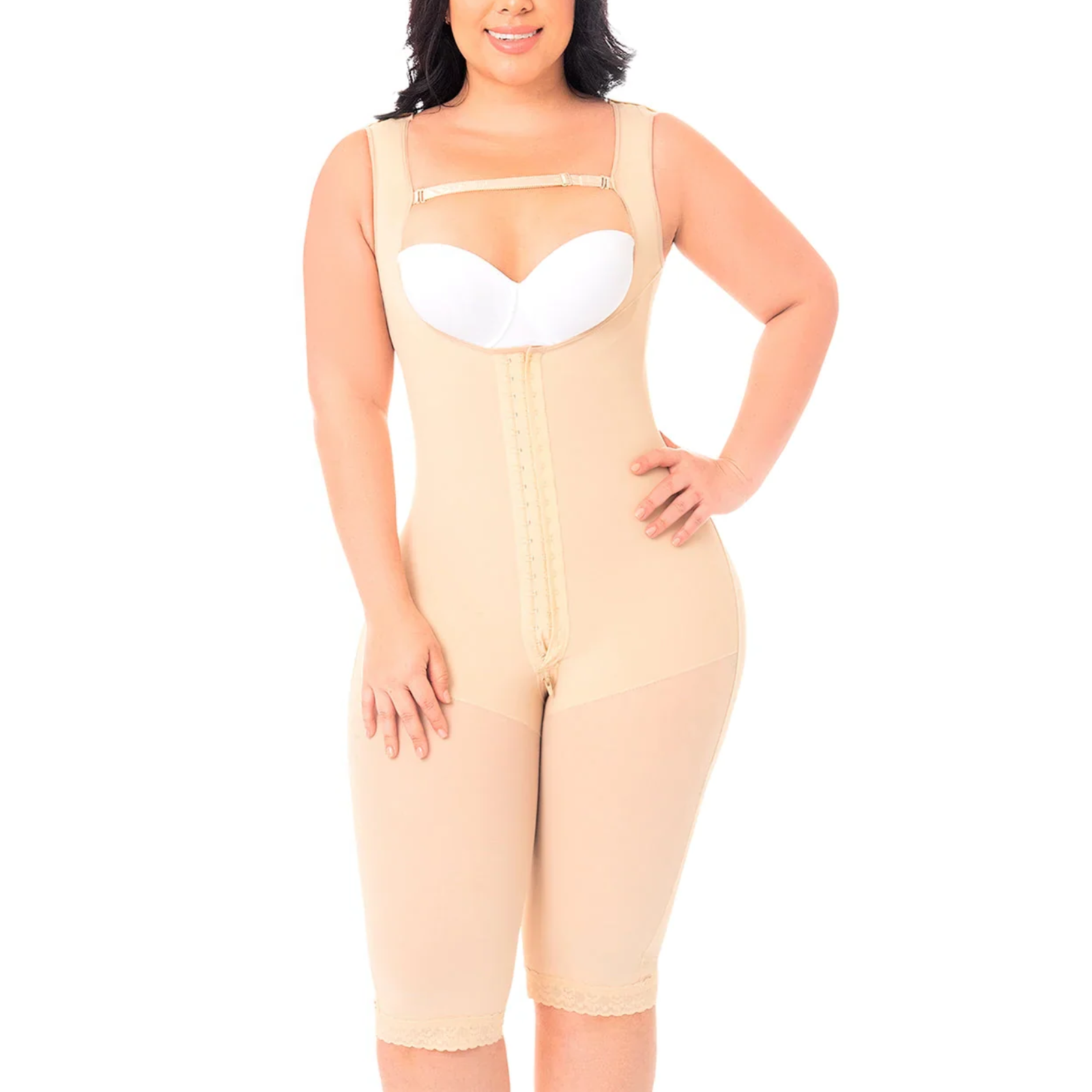 Woman wearing a beige body shaper with a white bra on a white background