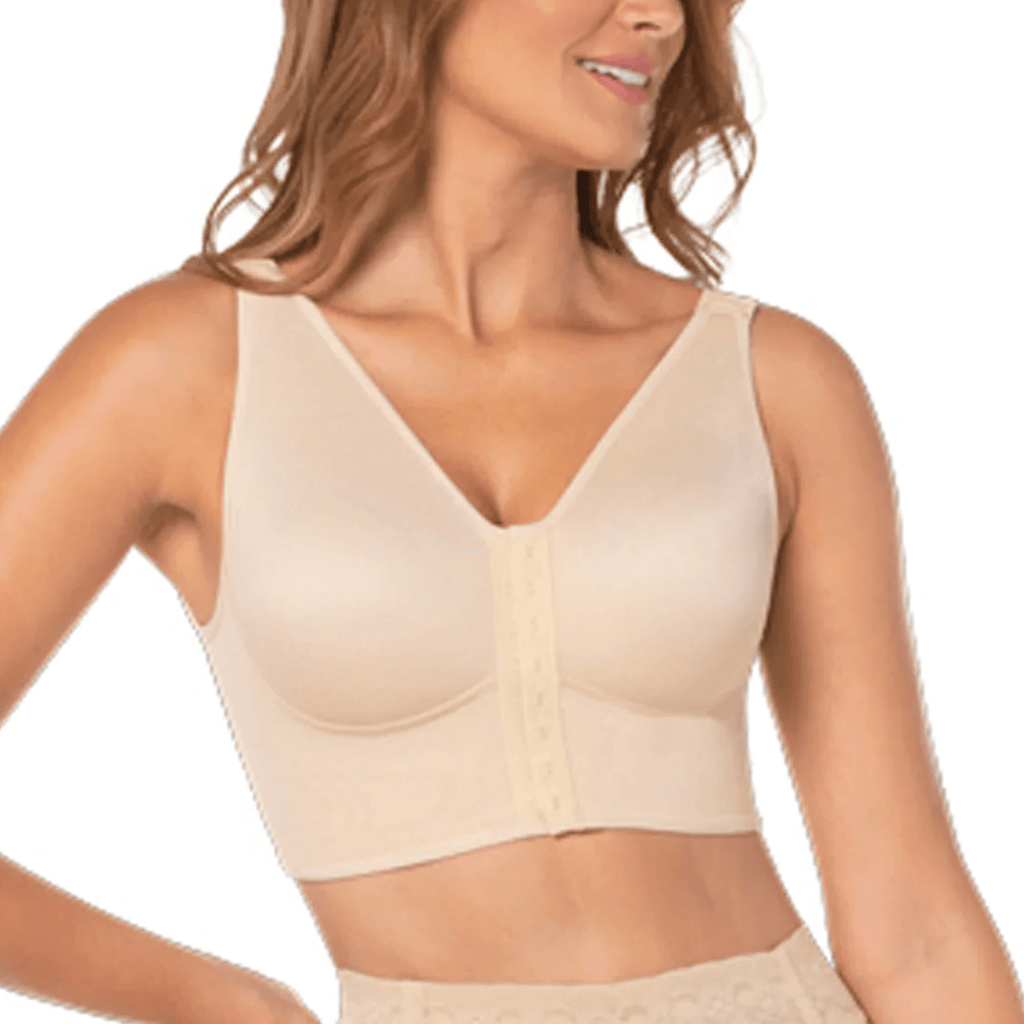 Woman wearing a beige compression garment on a white background