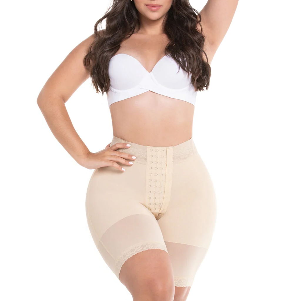 Woman wearing a white bra and beige shapewear on a white background