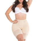 Woman wearing a white bra and beige shapewear on a white background