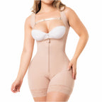 Beige full-body shapewear with front zipper, lace trim, and crossback design, worn with white bra, front view