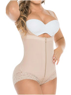 Woman wearing a beige shapewear bodysuit with a white bra.