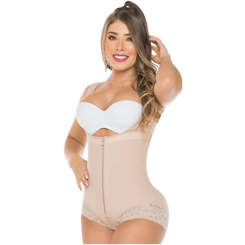 Woman wearing a beige shapewear bodysuit with a white bra on a white background