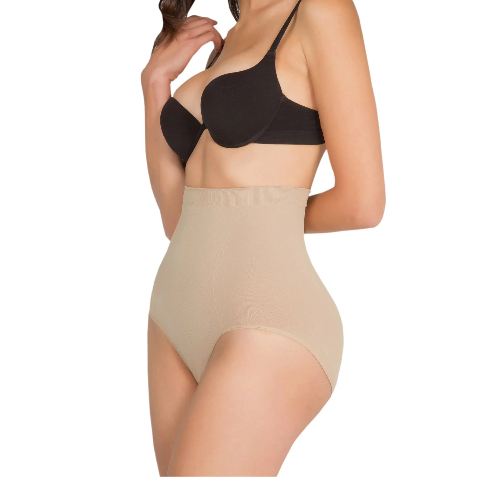 Woman wearing a black bra and beige shapewear on a white background