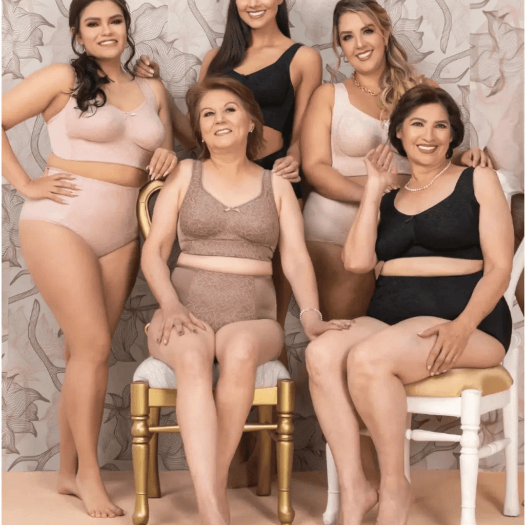 Group of women wearing lingerie posing together against a floral wallpaper background.