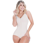 Woman wearing a beige bodysuit on a white background