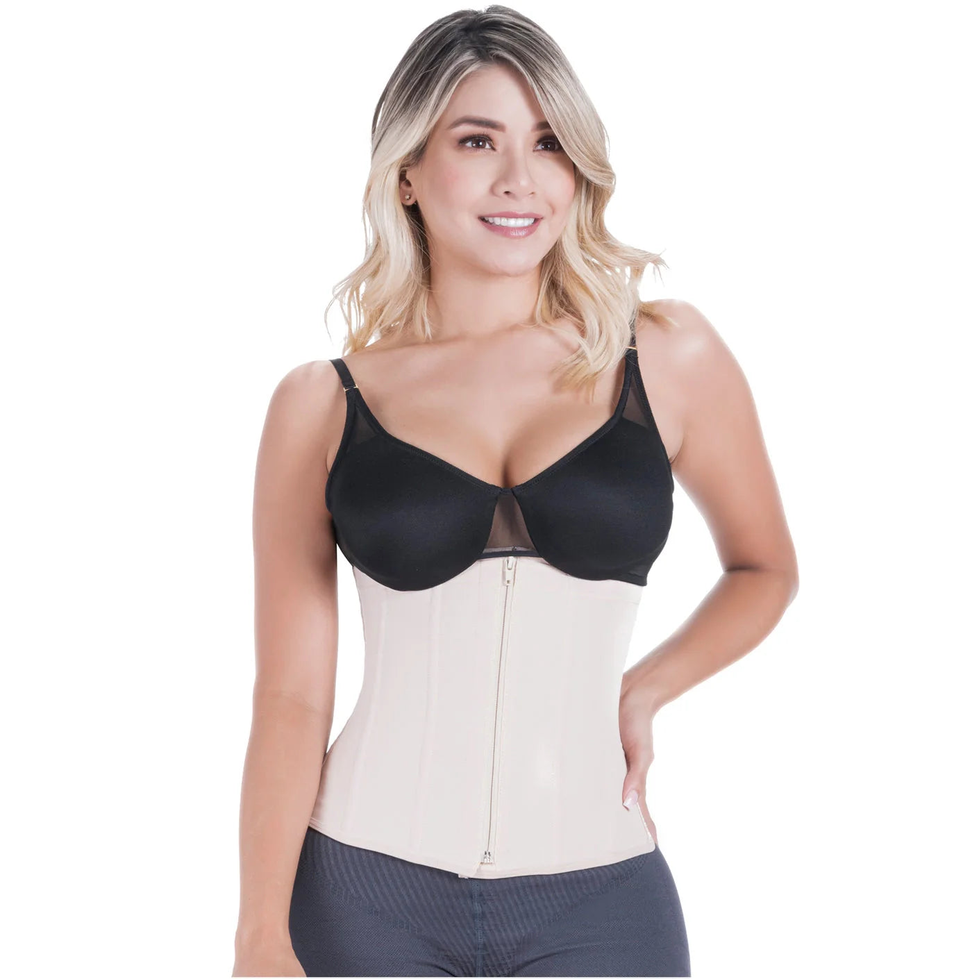 Woman wearing a black bra and beige waist trainer on a white background