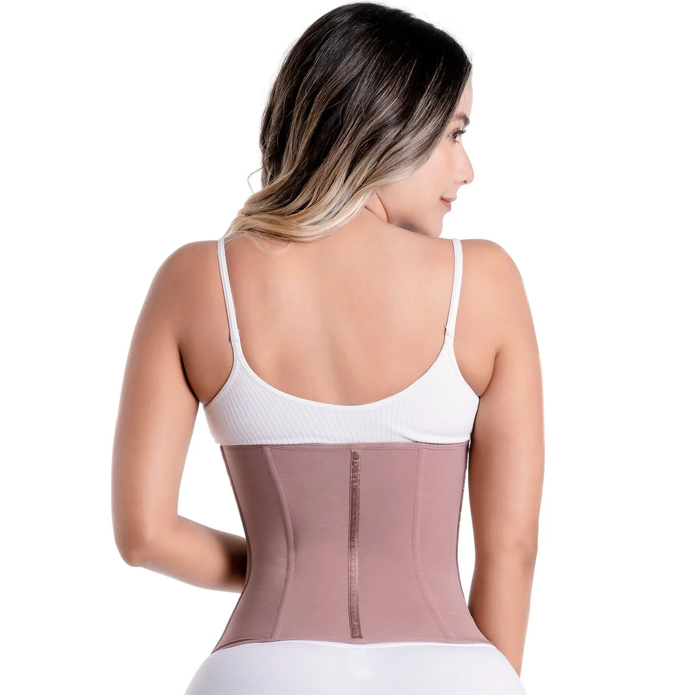 Woman wearing a transparent waist trainer over a white tank top on a white background