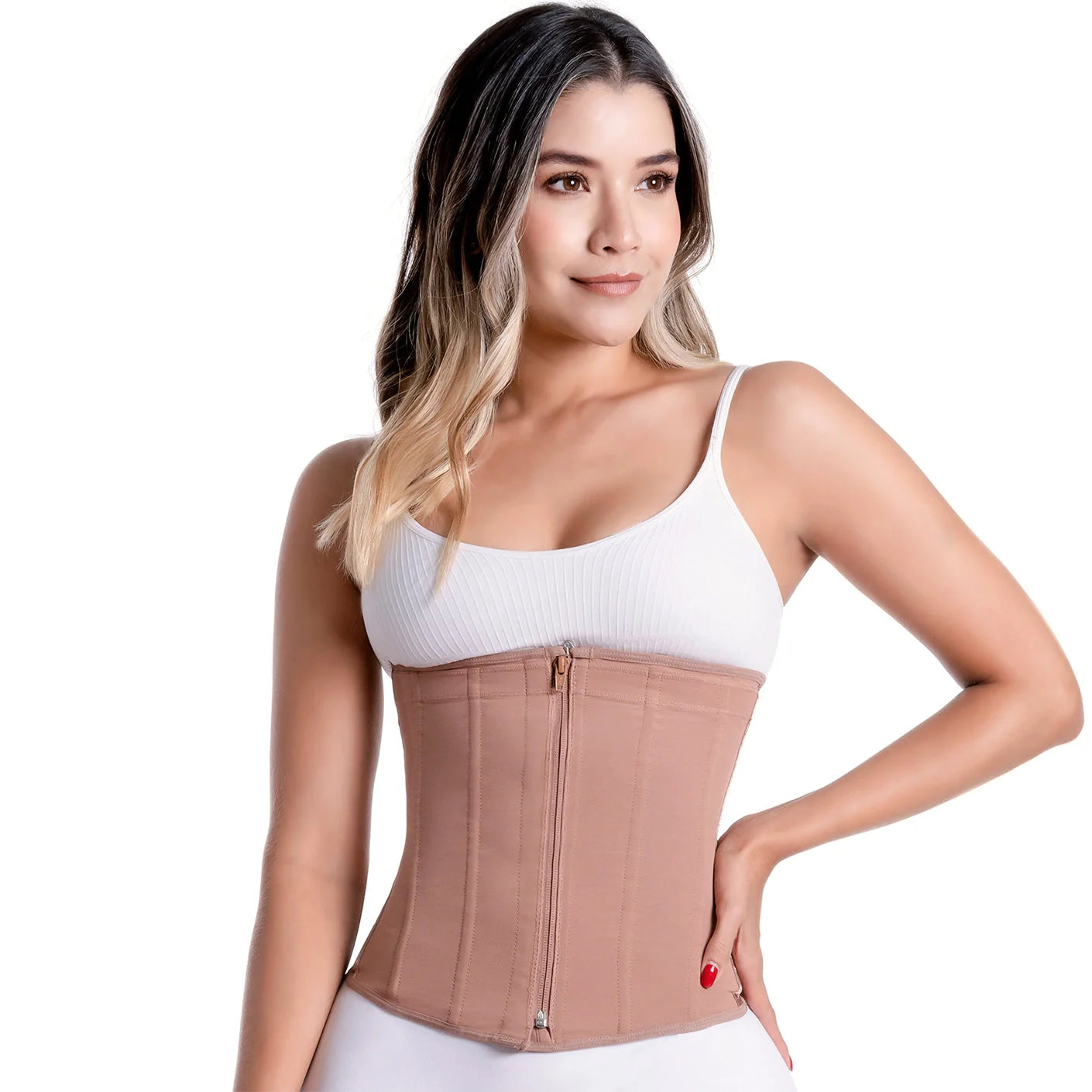 Woman wearing a beige waist trainer with a white top on a plain background