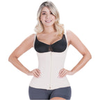 Woman wearing a black waist trainer on a white background