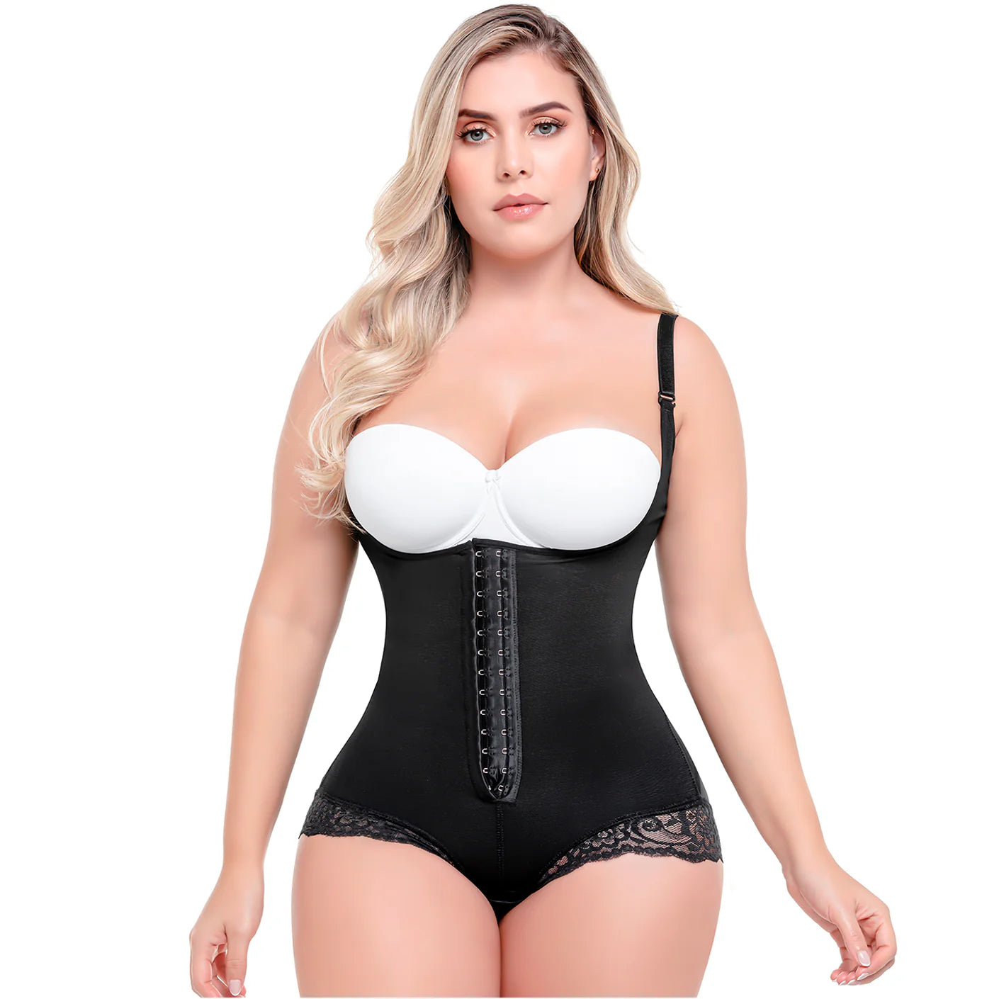 Woman wearing a black shapewear bodysuit with a white bra on a white background