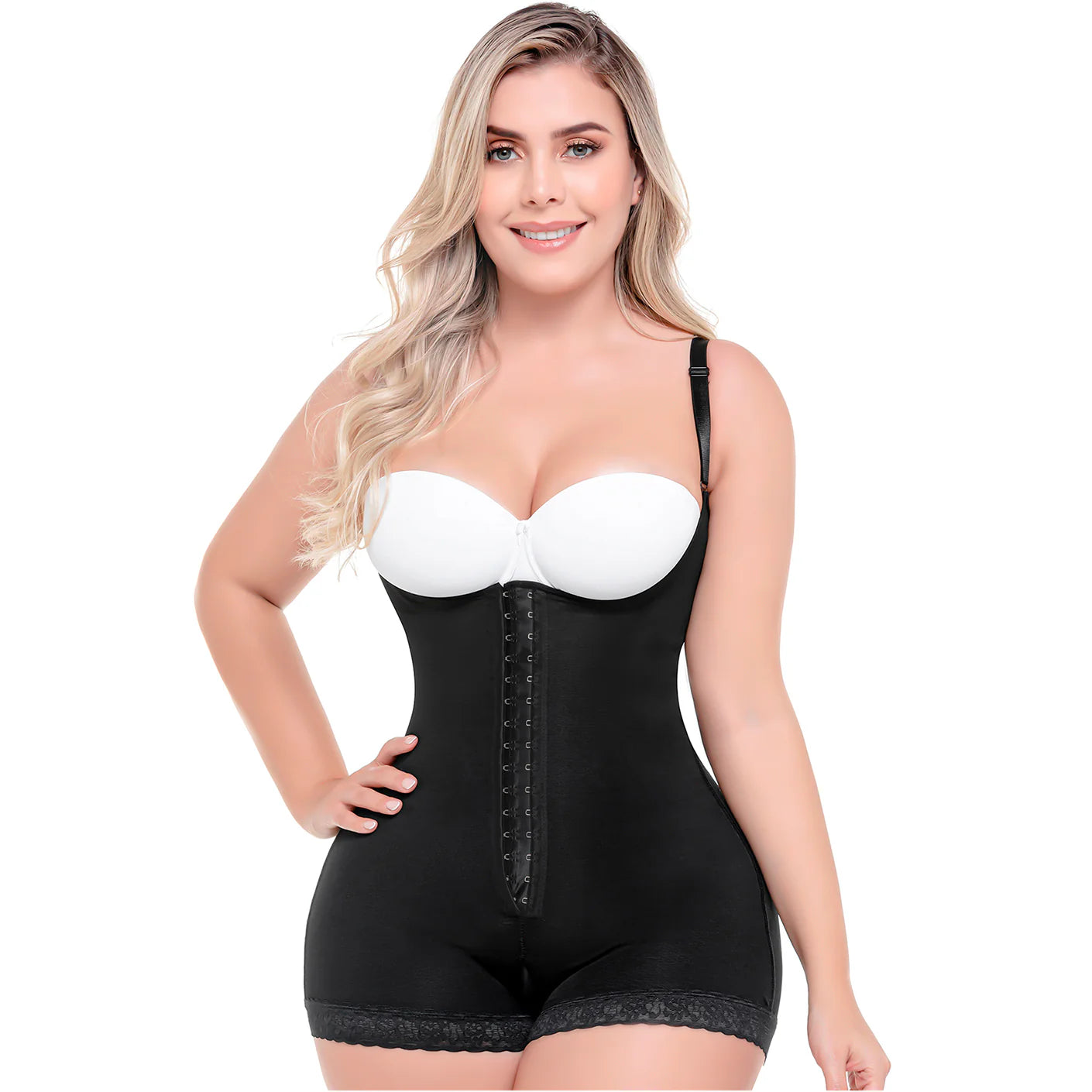 Woman wearing a black shapewear bodysuit with a white bra on a white background