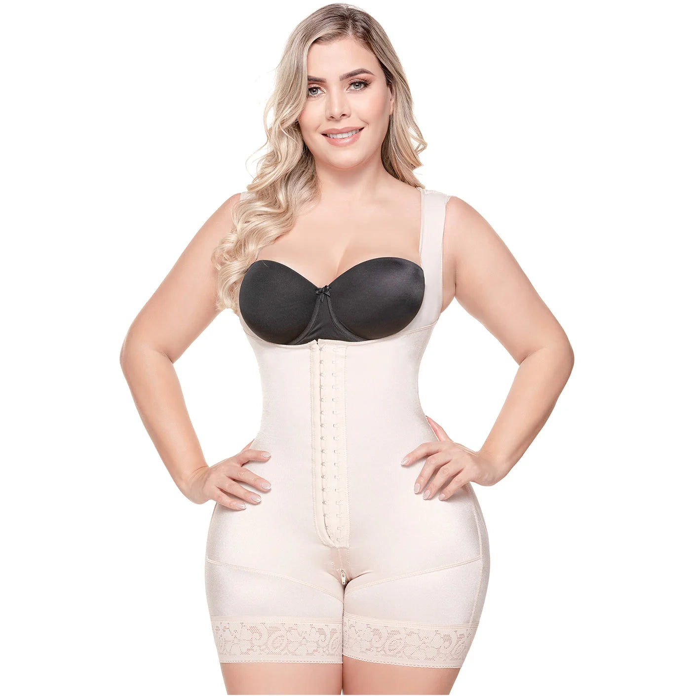 Woman wearing a beige body shaper with a black bra on a white background