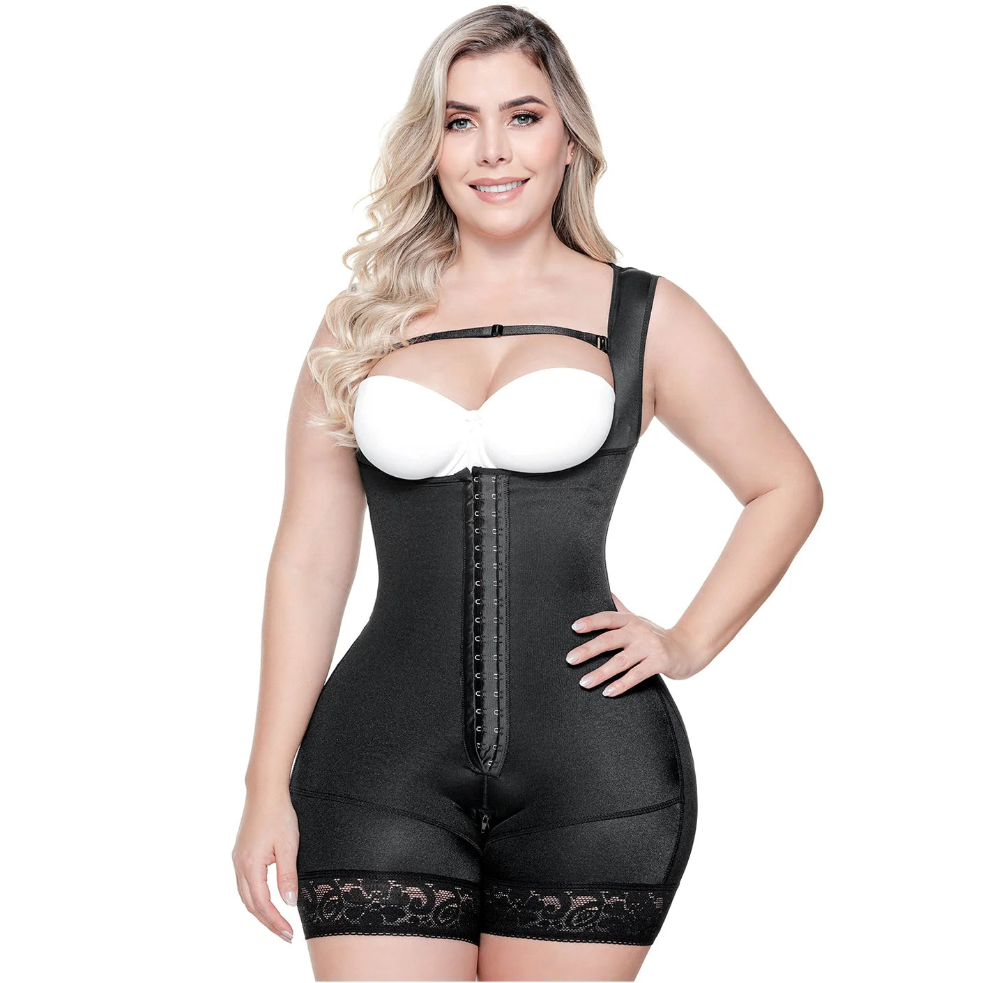 Woman wearing a black shapewear garment with a white bra on a white background