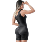 Woman wearing a black bodysuit on a white background