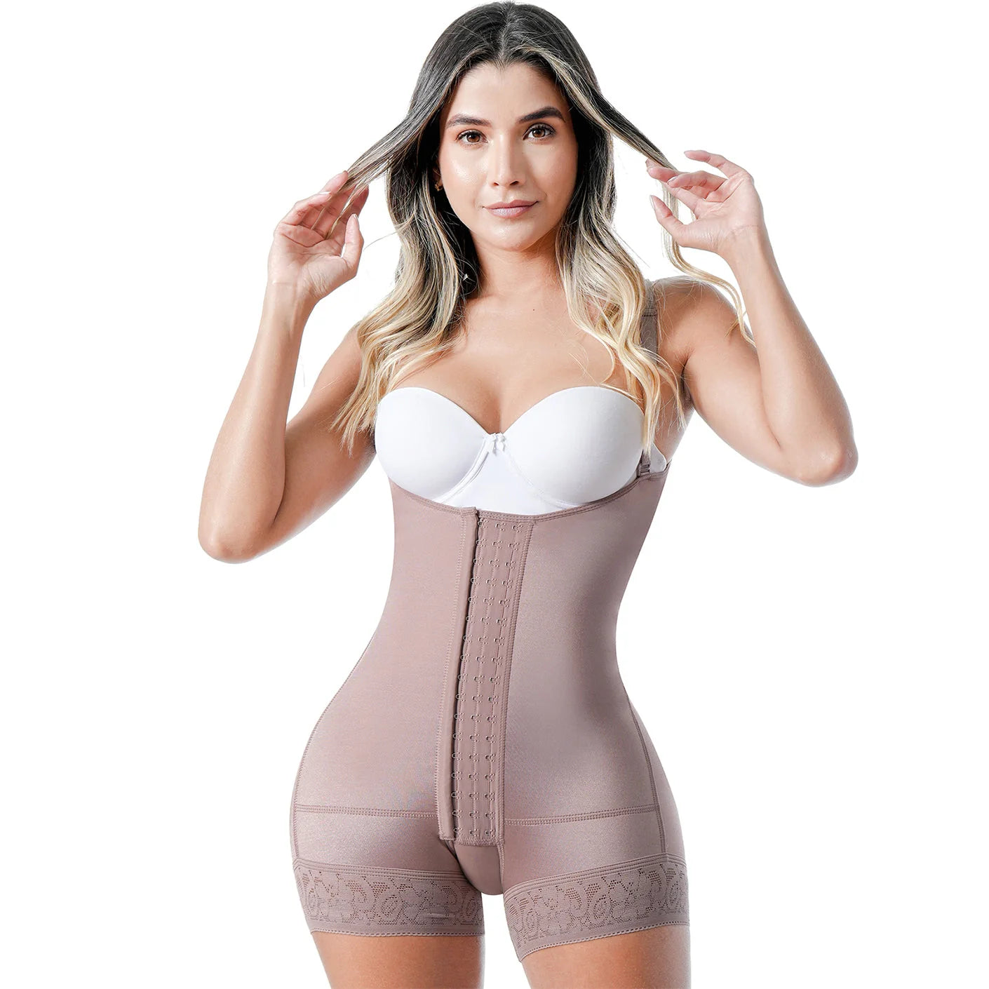 Woman wearing a beige shapewear garment on a white background