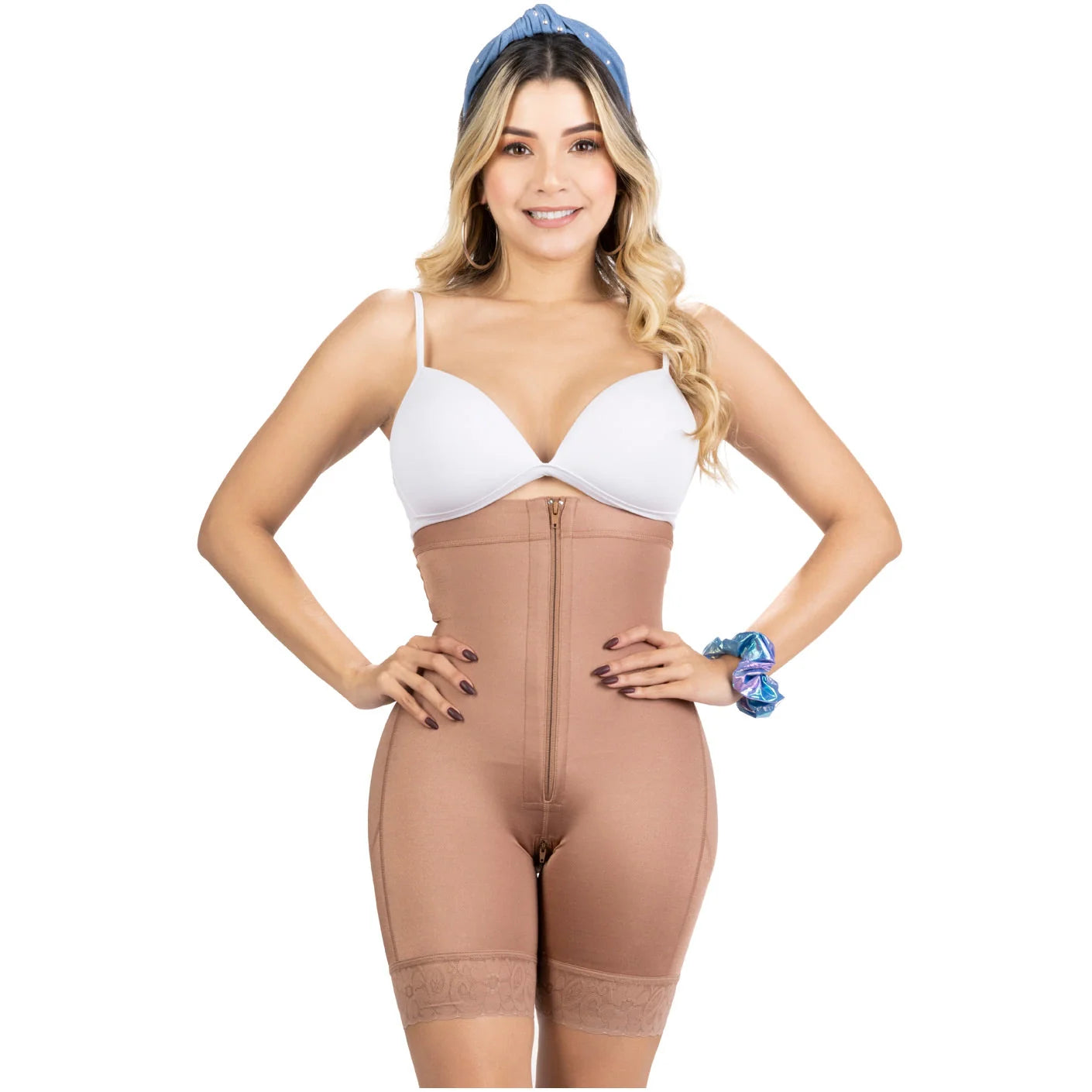 Woman wearing a beige shapewear bodysuit on a white background