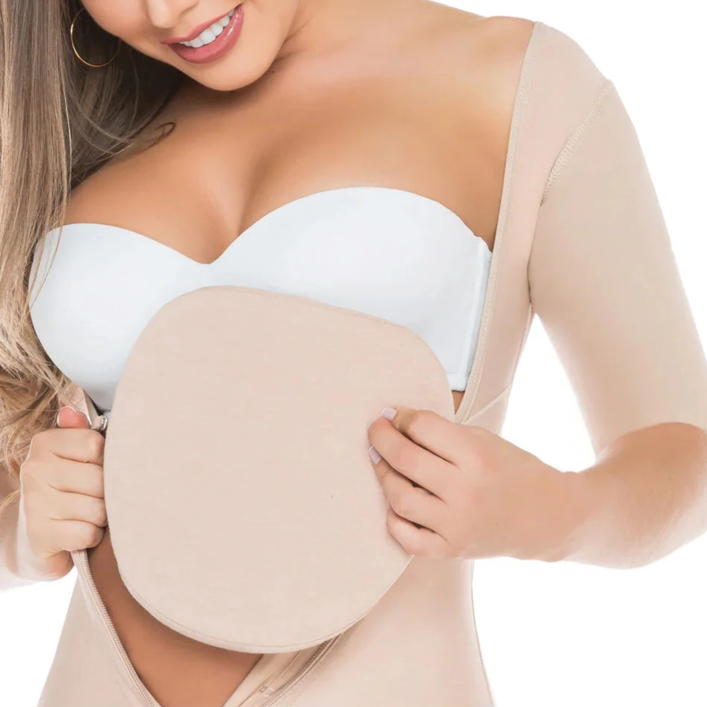 Woman wearing a white strapless top and beige compression garment on a white background