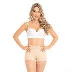 Woman wearing a white bra and beige shorts on a white background