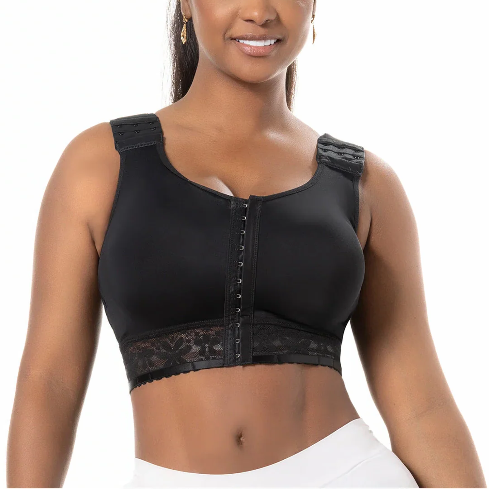Black compression garment worn by a model on a white background